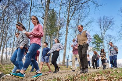 people walking a forest trail